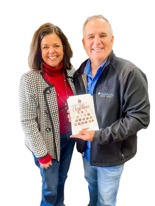 Kimberly Fish with fellow church member showing off her Christmas Comfort book